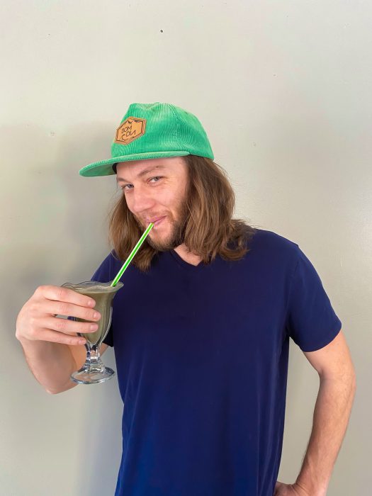 Blooming botanicals owner sipping shamrock shake with striped straw
