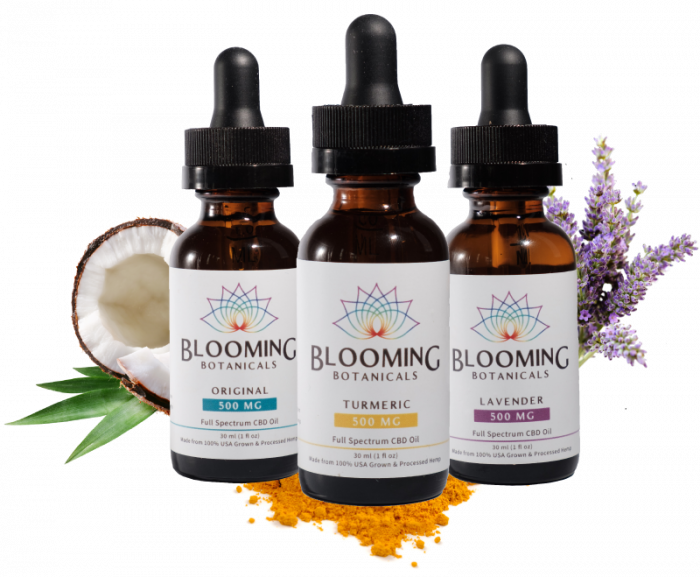 Brown dropper bottles with labels containing turmeric CBD, original CBD, and Lavender CBD pictured with fresh herbs
