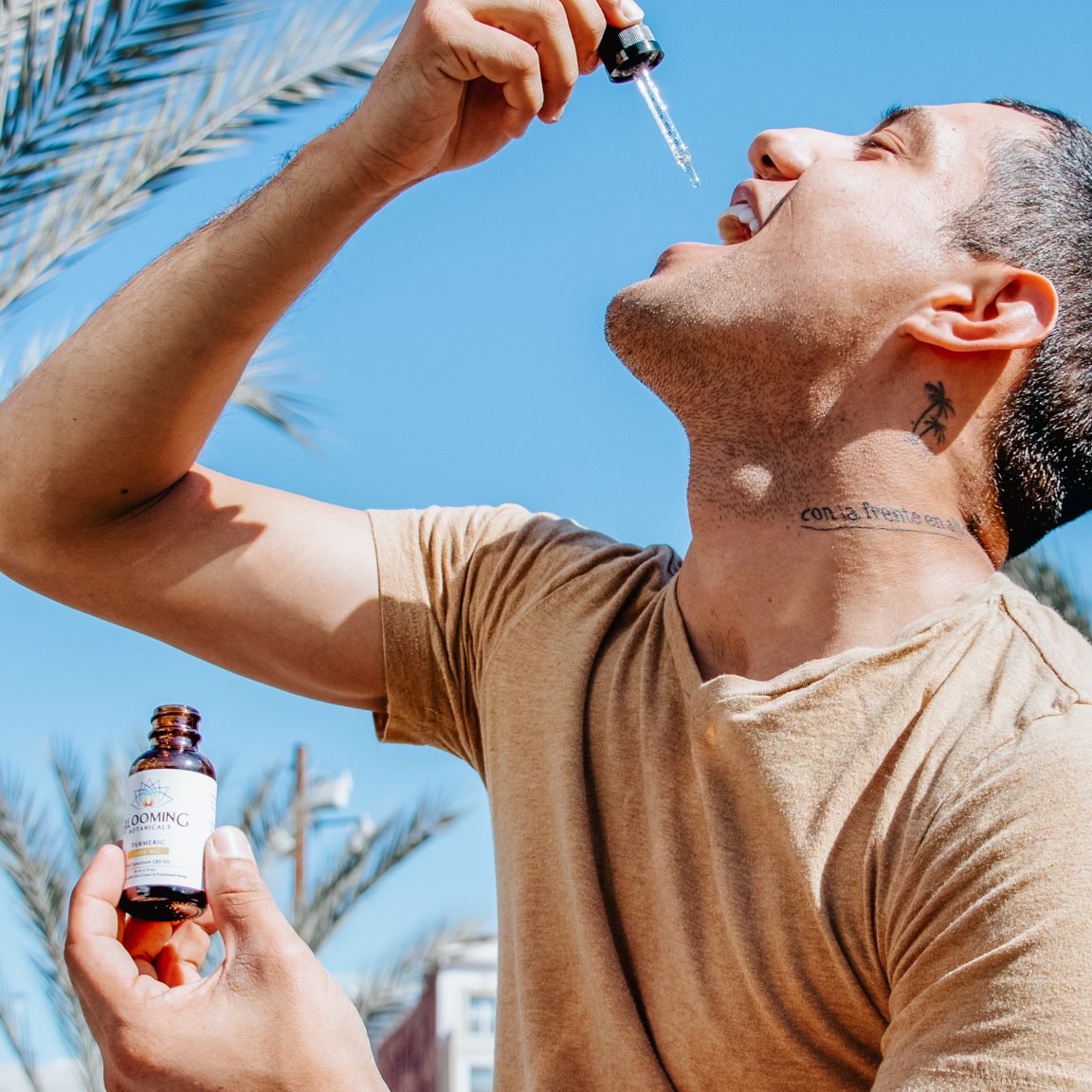 Man taking a CBD tincture outside in the sunshine.