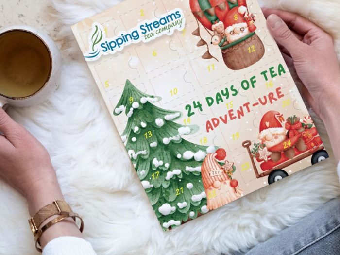 Sipping Streams Tea Company cute advent calendar with woman holding it.